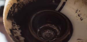Skateboard wheel close up showing worn edges and bearing
